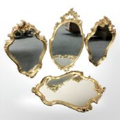 Four ornate reproduction gilt framed mirrors,