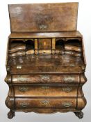 An early 20th century continental burr walnut bureau on claw and ball feet (as found),