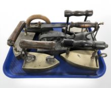 A group of 19th century cast iron and brass irons.