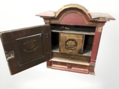 A 19th century painted and gilt single door wall cabinet,