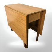 A teak veneered drop leaf dining table,