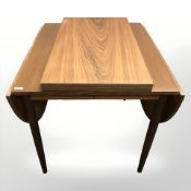 A 20th century Danish teak drop leaf extending dining table, with two leaves, width 86 cm.