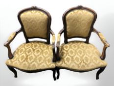 A pair of continental carved beech salon armchairs in gold upholstery.