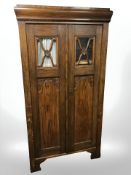 An early 20th century carved oak and pine double door cabinet,