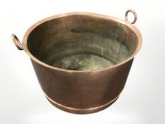 A 19th century copper twin handled cooking pot, diameter 55 cm.