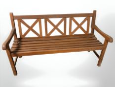 A stained teak garden bench, 152 cm x 66 cm x 87 cm.
