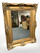 An ornate Victorian style gilt framed over mantel mirror,