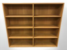 A continental oak veneered open bookcase with adjustable shelves, 135 cm x 26 cm x 118 cm.