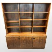 A 20th century Danish open bookcase, fitted cupboards beneath, 150 cm x 40 cm x 176 cm.