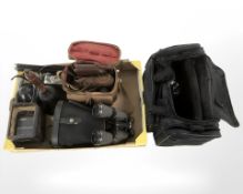 Two camera bags containing several vintage cameras, including Olympus,