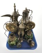 Two eastern brass coffee pots, a further copper plated jug,
