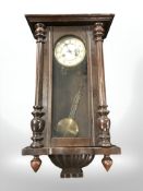 An early 20th century continental oak wall clock with enamelled dial,