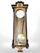 An early 20th century continental walnut Vienna-style wall clock, length 101 cm.
