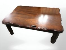 A reproduction stained rustic coffee table, length 104 cm.