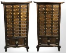 A pair of 20th century Korean lacquered elm cabinets each fitted thirty drawers above a double door