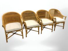 A set of four wicker conservatory armchairs.