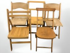 Five various folding beech chairs.