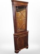 A reproduction yew wood corner cabinet,