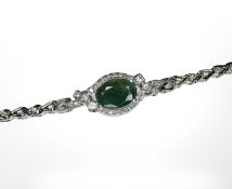 A 14ct white gold emerald and diamond bracelet, the oval cut emerald 3.