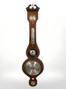 A reproduction barometer with silvered dial, length 95 cm.