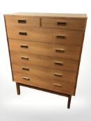 A 20th century Danish teak and pine seven drawer chest,