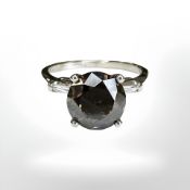 A platinum diamond solitaire ring, the cognac brown brilliant cut diamond weighing 3.