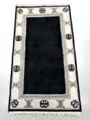 A Chinese woolen rug on black ground,