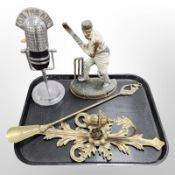 A cast iron painted door stop in the form of a W G Grace, a brass shoe horn,