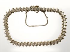 A 10ct yellow gold diamond bracelet, set with fifty diamonds, approximately 5ct.