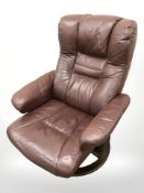 A contemporary Danish Burgundy leather swivel armchair.