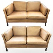 A pair of late 20th century Danish stitched tan leather two seater settees,