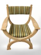 A Danish blond oak X-framed armchair in striped fabric,