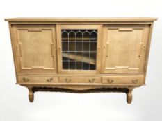 A 20th century Danish blond oak and stained leaded glass sliding door sideboard,