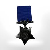 A reproduction military medal on blue suspension ribbon