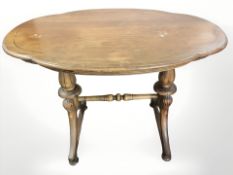 A continental walnut shaped top occasional table, 96 cm x 65 cm x 70 cm.