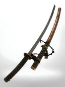 An ornate reproduction Japanese katana, in scabbard.