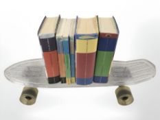 A small skateboard and six Harry Potter volumes.
