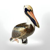 A Royal Crown Derby Brown Pelican paperweight, with silver stopper.