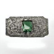 An Art Deco style bar brooch set with a green stone, width 3.5 cm.