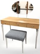 A contemporary mirrored dressing table on chrome legs,