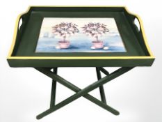 A painted serving tray on folding stand, width 60 cm.