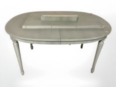 A painted extending dining table, with two leaves,