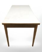 A 20th century melamine topped drop leaf extending dining table,
