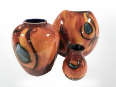 Three Poole pottery vases, largest 18 cm.