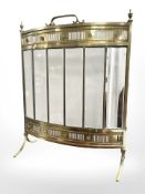 A brass and glass bow-front fire screen,