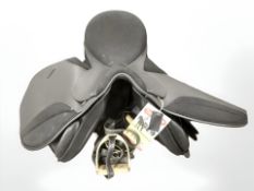 A Thorowgood saddle, with brass stirrups, retaining retail tag.