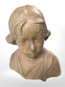 A pottery bust of a boy, height 32 cm.