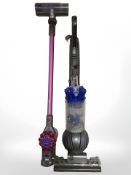 A Dyson V7 motorhead handheld stick vacuum and a Dyson DC41 upright vacuum.