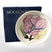 A Moorcroft Magnolia pin dish, diameter 11.5 cm, boxed.