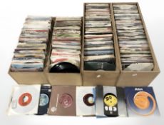 Four wooden crates containing a large quantity of vinyl 45 singles, including Madness, The Specials,